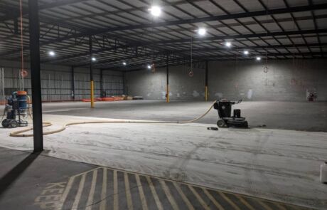 Grinding concrete floor inside Gold Coast warehouse